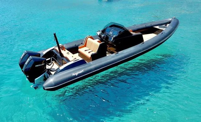Slide: The Image of Roughneck RIB 1010 boat, 2022 model, floating on clear blue water. - 10