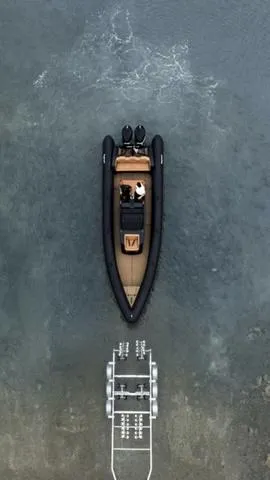 Slide: The Image of Aerial view of 2022 Roughneck RIB 1010 boat on water, approaching a dock. - 21