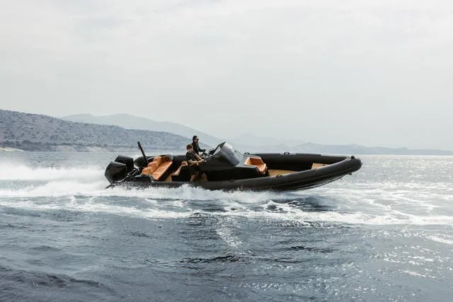 Slide: The Image of Roughneck RIB 1010 boat cruising on open water, 2022 model. - 23