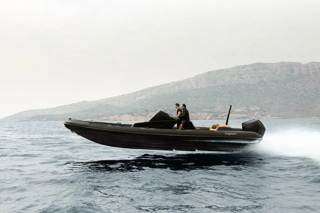 Slide: The Image of Roughneck RIB 1010 boat speeding on water, 2022 model, with mountainous backdrop. - 24
