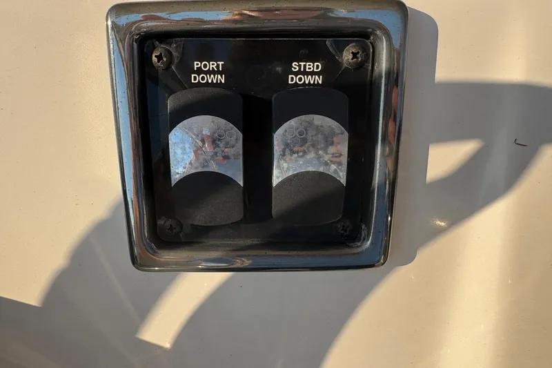 Slide: The Image of Boat control panel with "Port Down" and "STBD Down" switches on a 2015 Cobia 201 Center Console. - 13