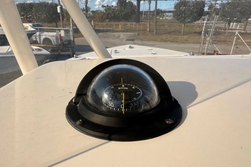 Slide: The Image of Compass on 2015 Cobia 201 Center Console boat, outdoor setting. - 14