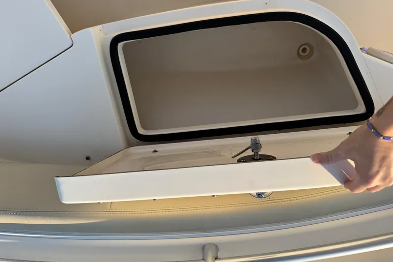 Slide: The Image of Open storage compartment on a 2015 Cobia 201 Center Console boat. - 20