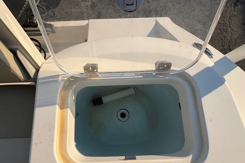 Slide: The Image of 2015 Cobia 201 Center Console boat livewell with open lid, showing interior details. - 26