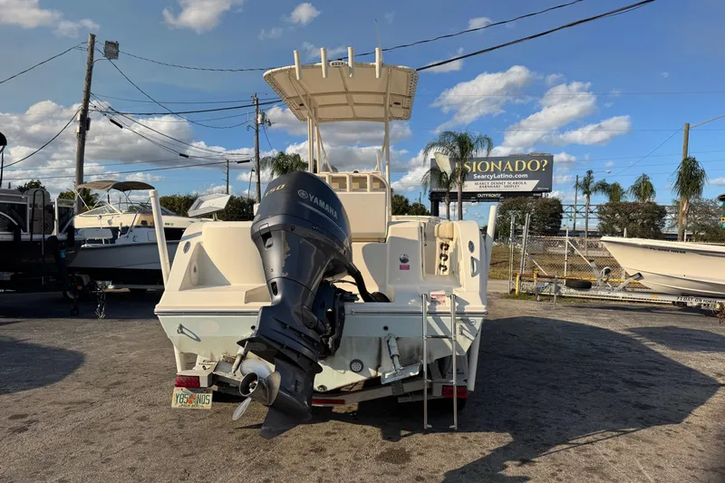 Slide: The Image of 2015 Cobia 201 Center Console boat with Yamaha outboard motor, parked outdoors. - 3