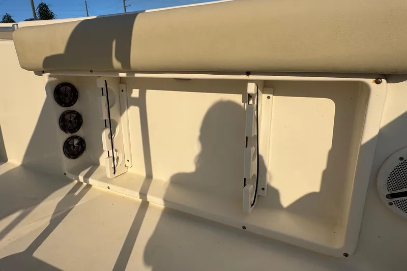 Slide: The Image of 2015 Cobia 201 Center Console boat interior with rod holders and speakers. - 32