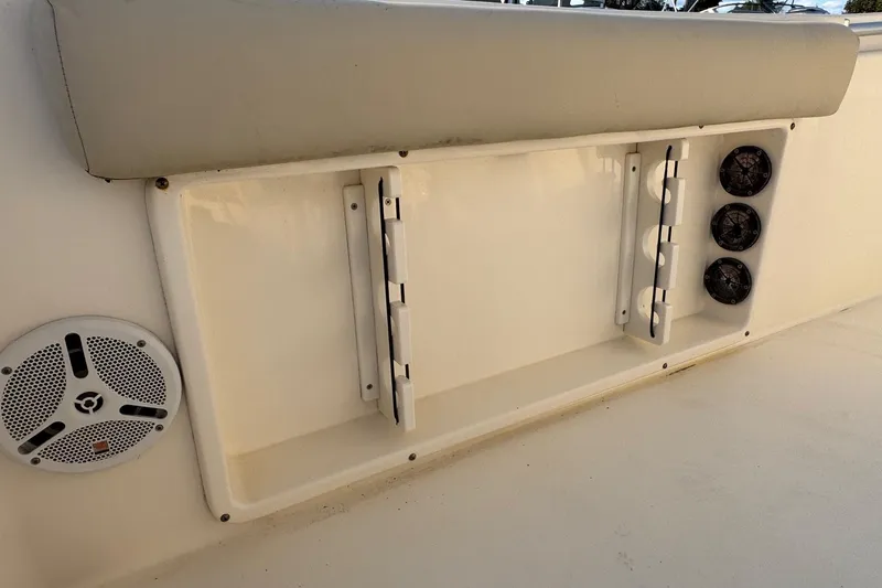 Slide: The Image of 2015 Cobia 201 Center Console boat interior with speakers and rod holders. - 33