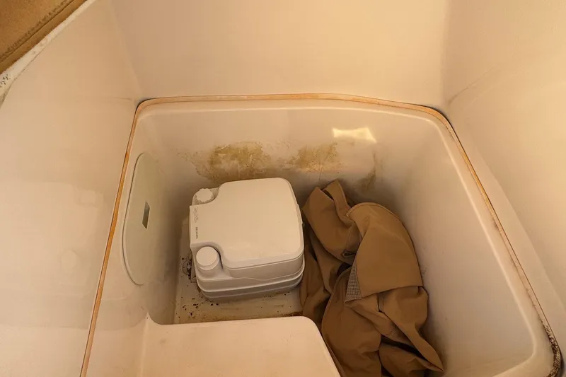 Slide: The Image of Portable toilet and fabric inside 2015 Cobia 201 Center Console boat compartment. - 35