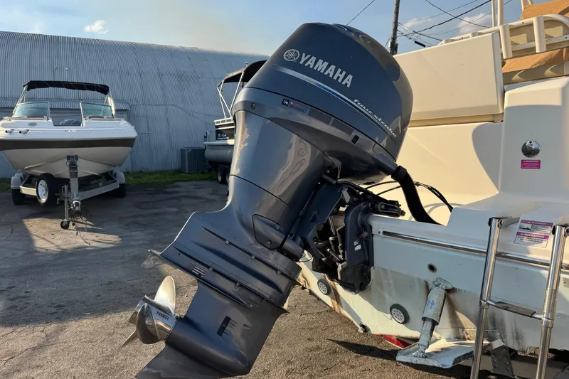 Slide: The Image of 2015 Cobia 201 Center Console with Yamaha outboard motor in a boatyard. - 40