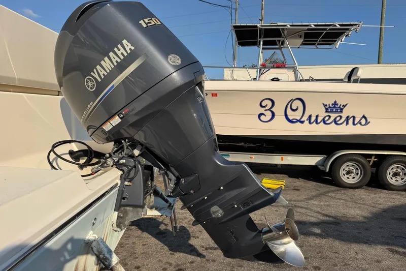 Slide: The Image of 2015 Cobia 201 Center Console with Yamaha 150 outboard motor, trailer in background. - 41