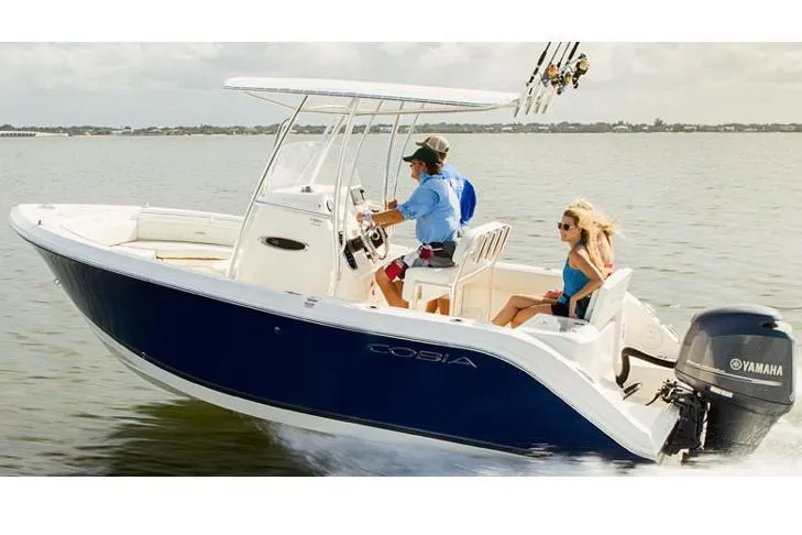 Slide: The Image of Manufacturer Provided Image: 2015 Cobia 201 Center Console boat cruising on water with Yamaha outboard motor. - 42