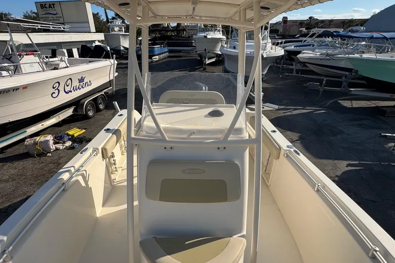 Slide: The Image of 2015 Cobia 201 Center Console boat in a marina with other vessels. - 6