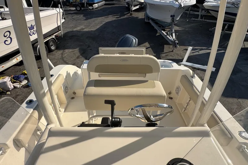Slide: The Image of 2015 Cobia 201 Center Console boat interior with steering wheel and seating. - 7