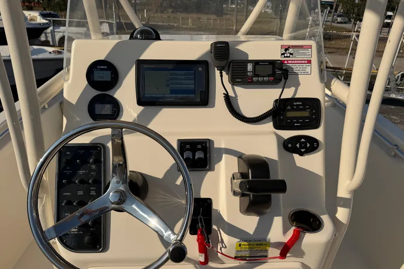 Slide: The Image of 2015 Cobia 201 Center Console boat dashboard with steering wheel and navigation controls. - 8