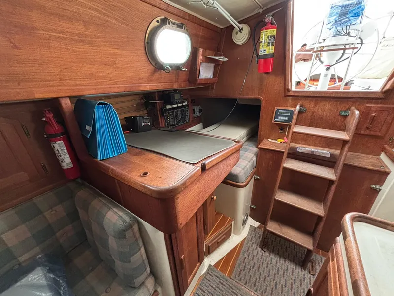 Slide: The Image of Interior of 1986 Pacific Seacraft 34 sailboat with wooden cabinetry and navigation station. - 18