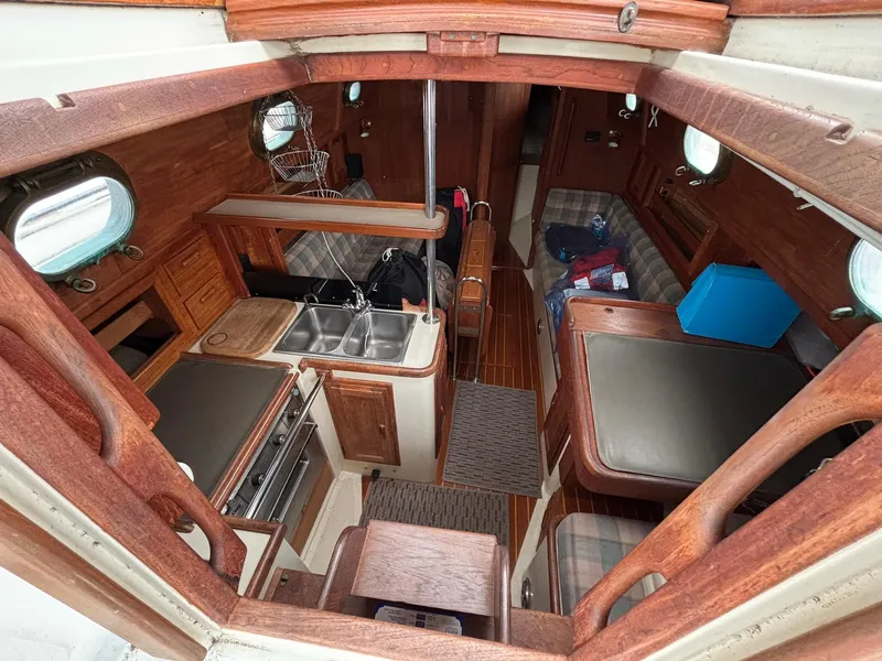 Slide: The Image of Interior of 1986 Pacific Seacraft 34 sailboat with wood finish and compact kitchen. - 21