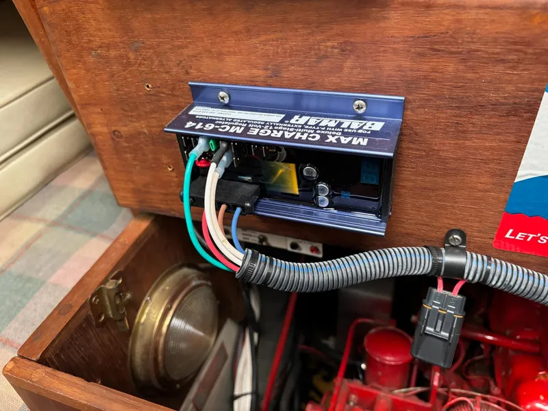 Slide: The Image of Battery charger installation on 1986 Pacific Seacraft 34 sailboat, featuring wiring and components. - 23