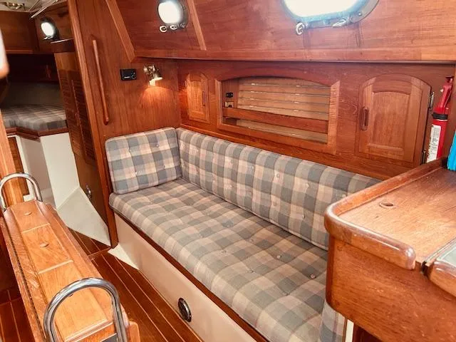 Slide: The Image of Interior of 1986 Pacific Seacraft 34 sailboat with plaid seating and wooden cabinetry. - 4