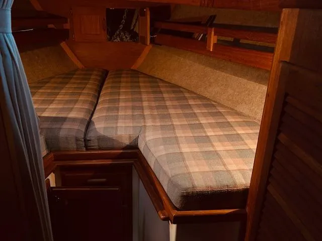 Slide: The Image of Cozy cabin interior of 1986 Pacific Seacraft 34 sailboat with plaid bedding. - 8