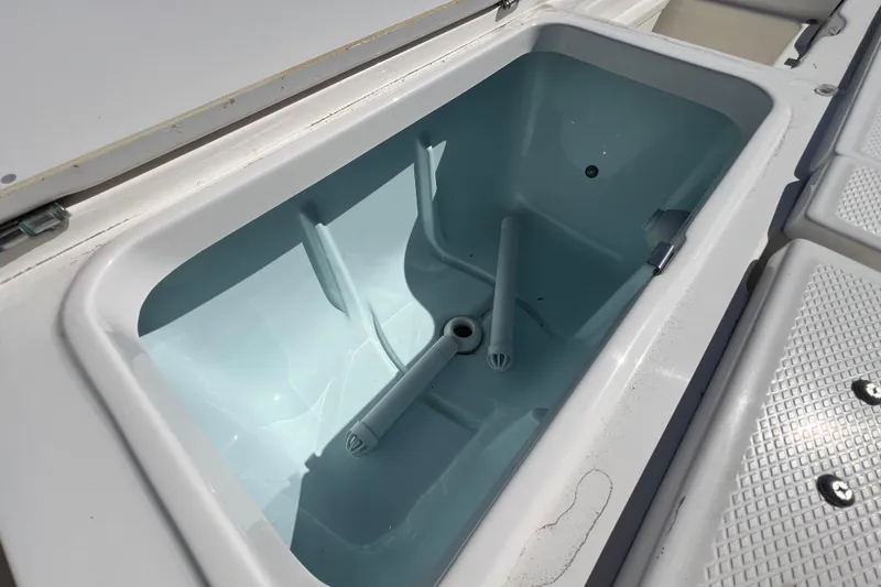 Slide: The Image of 2024 Robalo 226 Cayman boat storage compartment, open and empty. - 11