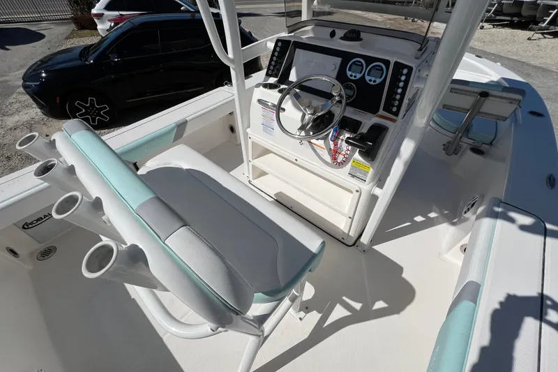 Slide: The Image of 2024 Robalo 226 Cayman boat interior with steering console and seating. - 12