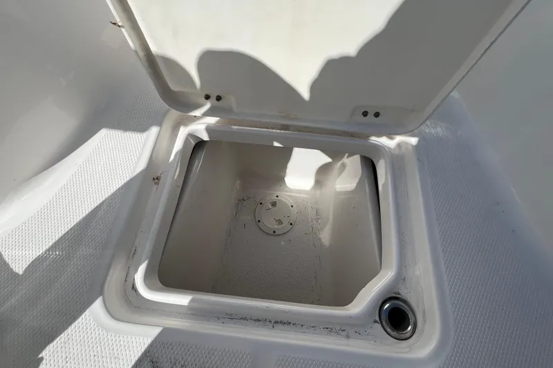 Slide: The Image of Open storage compartment on 2024 Robalo 226 Cayman boat deck. - 21