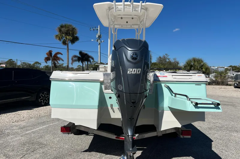 Slide: The Image of 2024 Robalo 226 Cayman boat with Yamaha 200 engine, parked outdoors. - 6