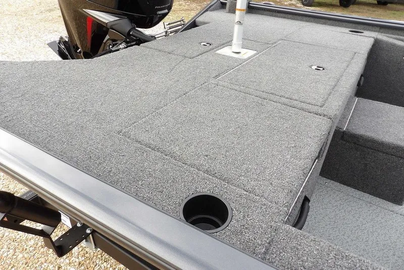 Slide: The Image of 2026 Lund 1875 Renegade boat deck with carpeted surface and storage compartments. - 14