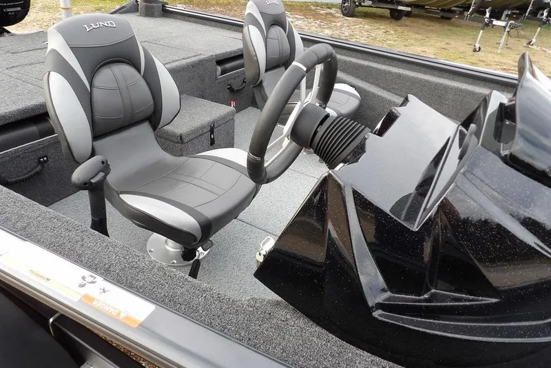Slide: The Image of 2026 Lund 1875 Renegade boat interior with steering wheel and seating. - 16