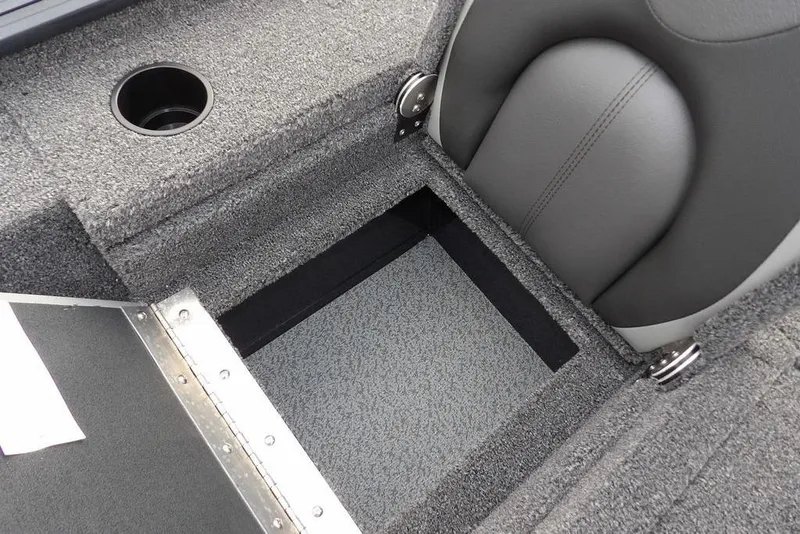 Slide: The Image of 2026 Lund 1875 Renegade boat interior with storage compartment and cup holder. - 17