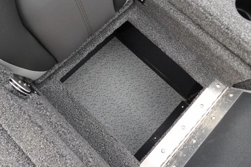 Slide: The Image of 2026 Lund 1875 Renegade boat storage compartment with gray carpet interior. - 18