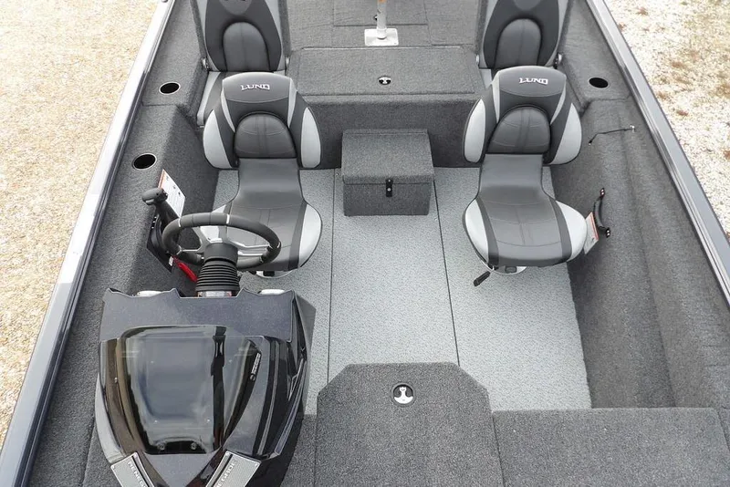 Slide: The Image of 2026 Lund 1875 Renegade boat interior with steering console and seating arrangement. - 21