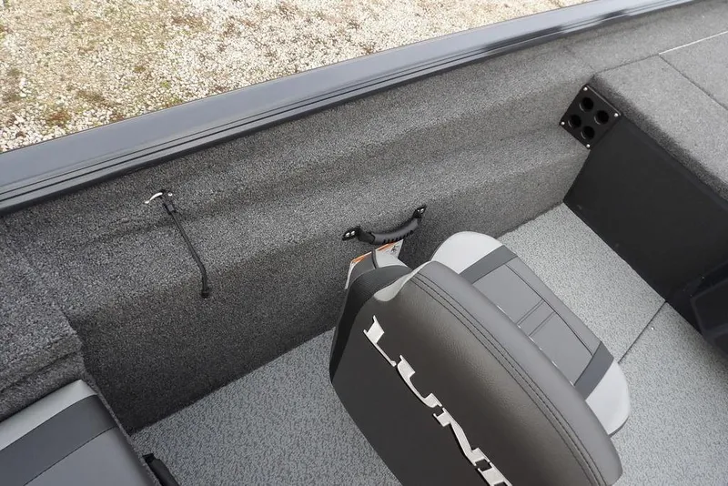 Slide: The Image of 2026 Lund 1875 Renegade boat interior with gray seating and carpeted flooring. - 22