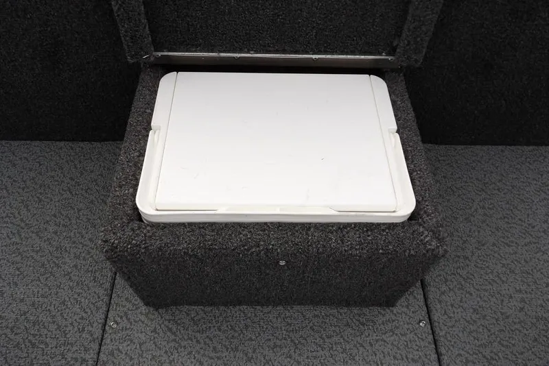 Slide: The Image of 2026 Lund 1875 Renegade boat storage compartment with white lid and carpeted interior. - 24