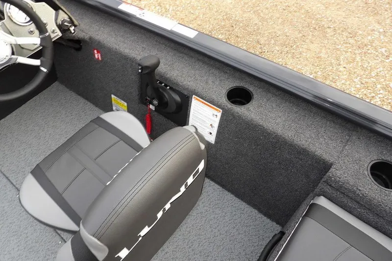 Slide: The Image of 2026 Lund 1875 Renegade boat interior with steering wheel and seating. - 25