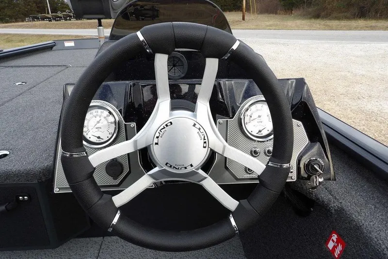 Slide: The Image of Steering wheel of 2026 Lund 1875 Renegade boat with dashboard gauges. - 26