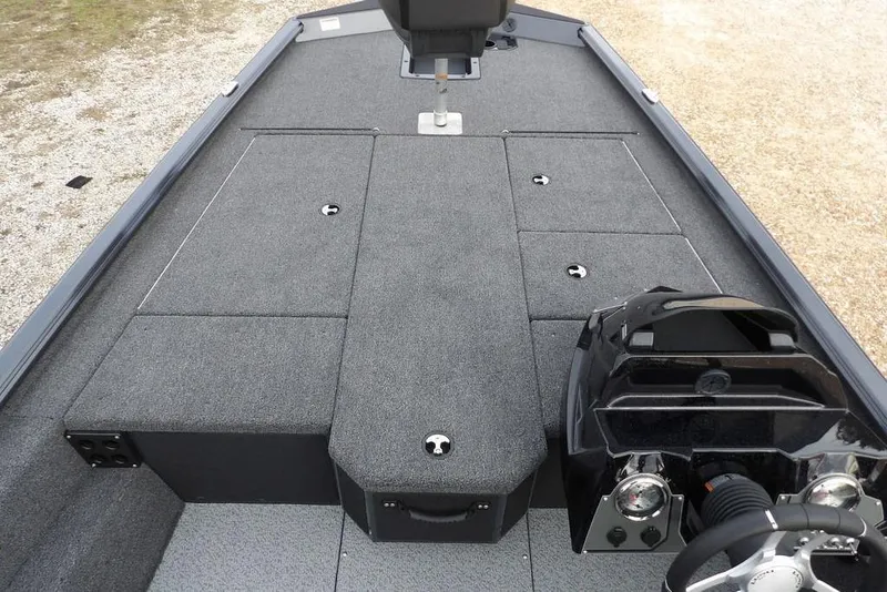 Slide: The Image of 2026 Lund 1875 Renegade boat interior with gray carpet and steering console. - 28