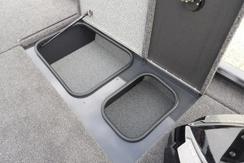 Slide: The Image of 2026 Lund 1875 Renegade boat storage compartments with carpeted interior. - 32