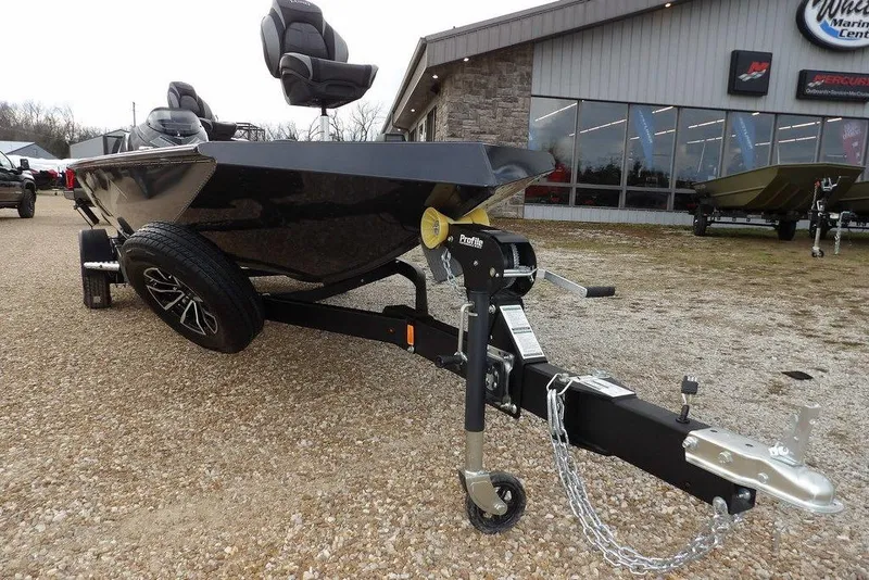 Slide: The Image of 2026 Lund 1875 Renegade boat on trailer outside marine center. - 37