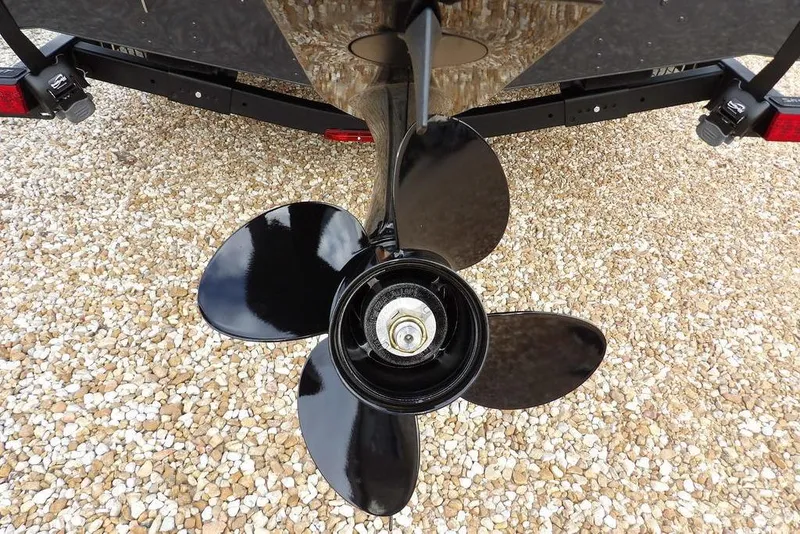 Slide: The Image of Propeller of 2026 Lund 1875 Renegade boat on gravel surface. - 38