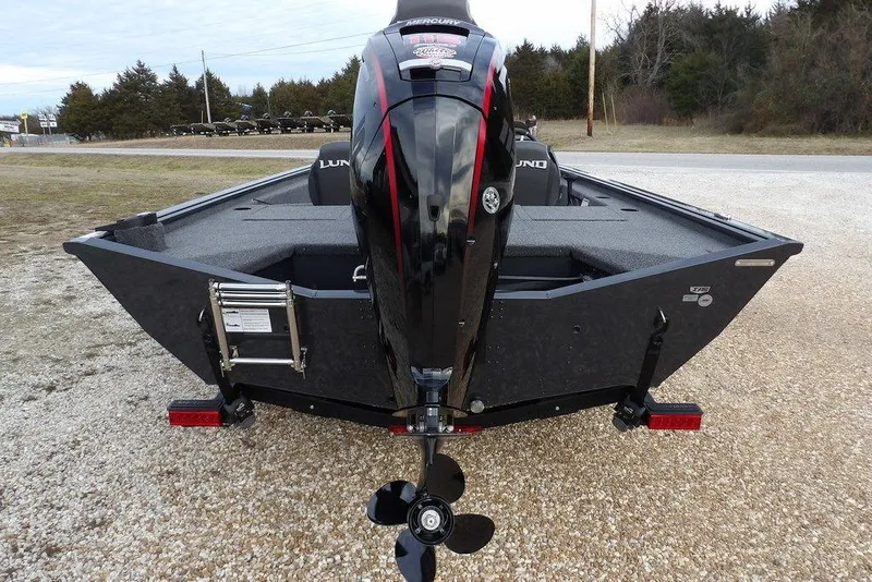Slide: The Image of 2026 Lund 1875 Renegade boat with powerful outboard motor, parked on gravel. - 4