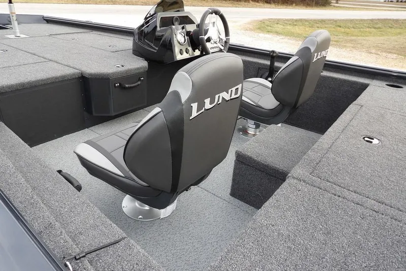 Slide: The Image of 2026 Lund 1875 Renegade boat interior with two seats and steering console. - 9