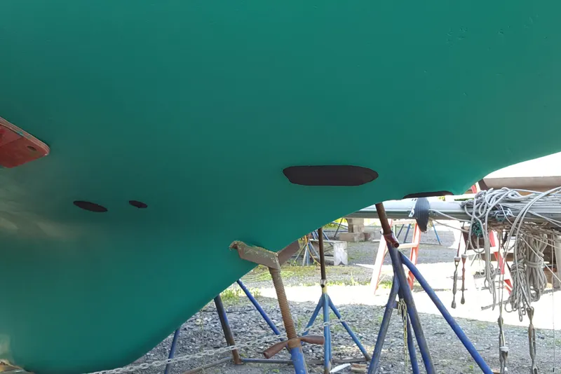 Slide: The Image of Bottom view of a 1973 Bristol 40 sailboat hull on stands, showing maintenance work. - 13