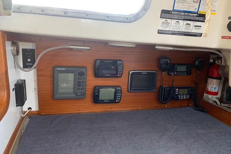 Slide: The Image of Navigation equipment in a 1973 Bristol 40 sailboat cabin, featuring radios and displays. - 2