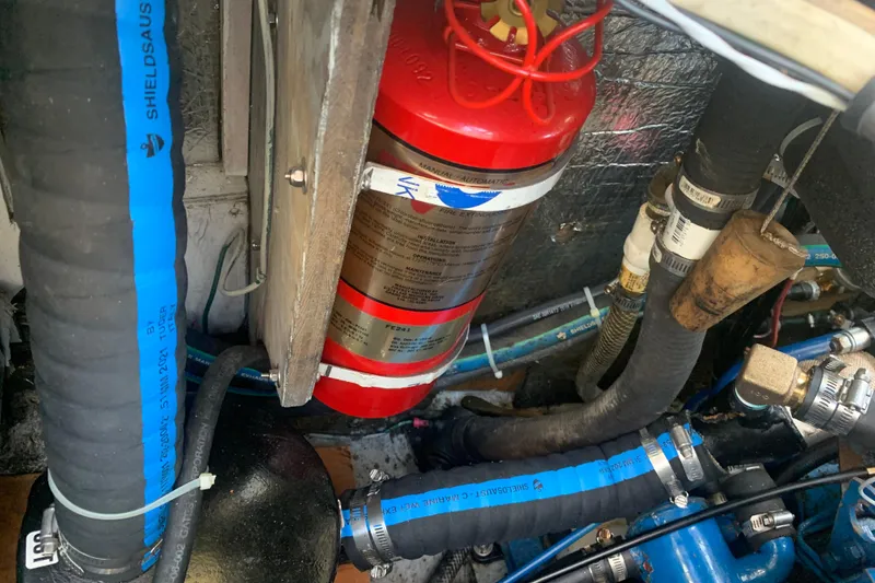 Slide: The Image of Engine compartment of a 1973 Bristol 40 with fire extinguisher and hoses. - 6