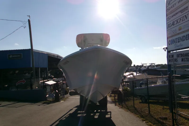 Slide: The Image of 2020 Key West 239 FS boat in marina, sunlit, with dealership signs and storage area. - 3