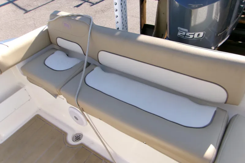 Slide: The Image of 2020 Key West 239 FS boat seating with beige and white cushions, Yamaha 250 engine visible. - 5