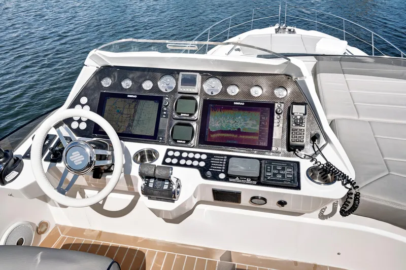 Slide: The Image of Cockpit of 2017 Sunseeker 68 Sport Yacht with advanced navigation controls and steering wheel. - 11