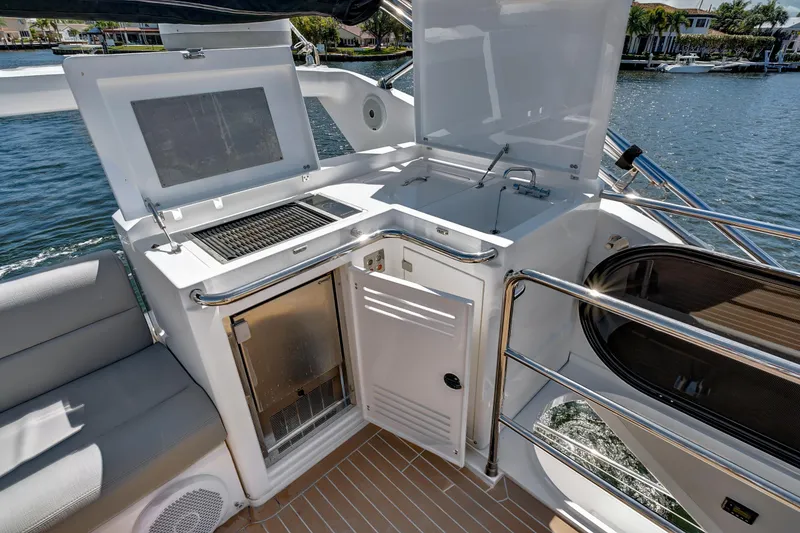 Slide: The Image of Outdoor kitchen on 2017 Sunseeker 68 Sport Yacht with grill and sink by the water. - 13