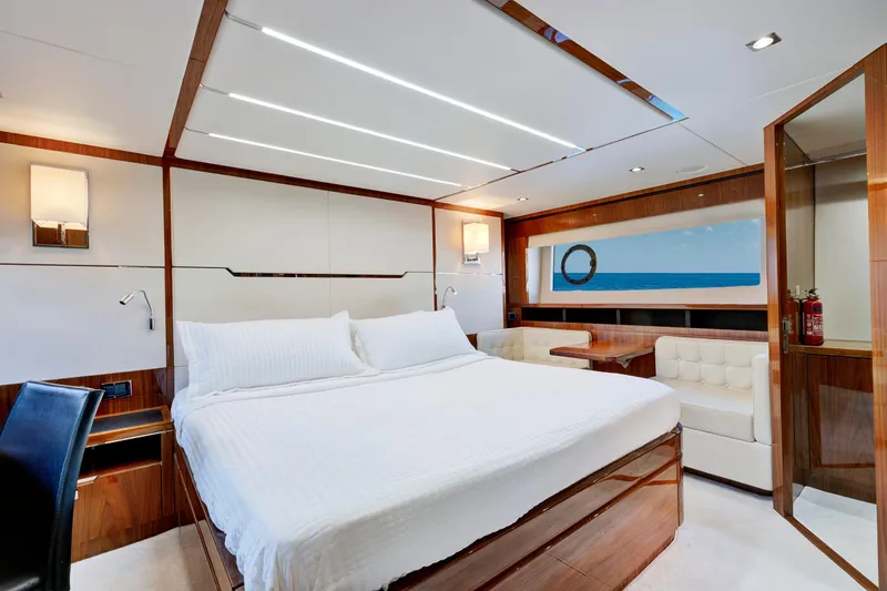Slide: The Image of Luxurious 2017 Sunseeker 68 Sport Yacht bedroom with elegant wood finishes and ocean view. - 24